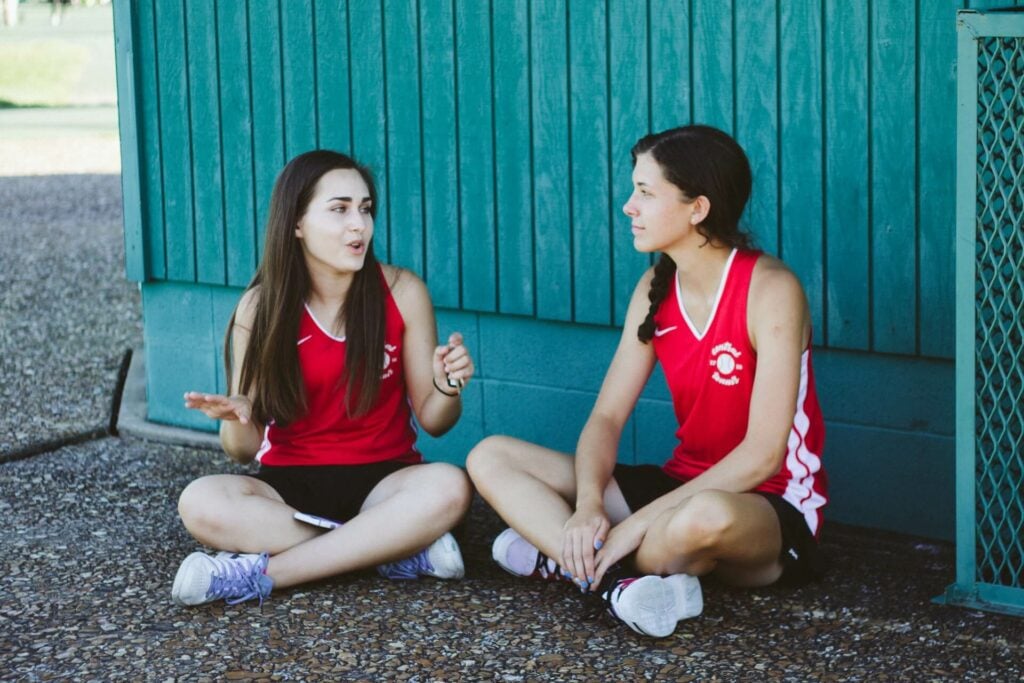 An image of two teenage girls talking representing Dare 2 Share's blog titled 5 Common Youth Pastor Struggles and How to Combat Them
