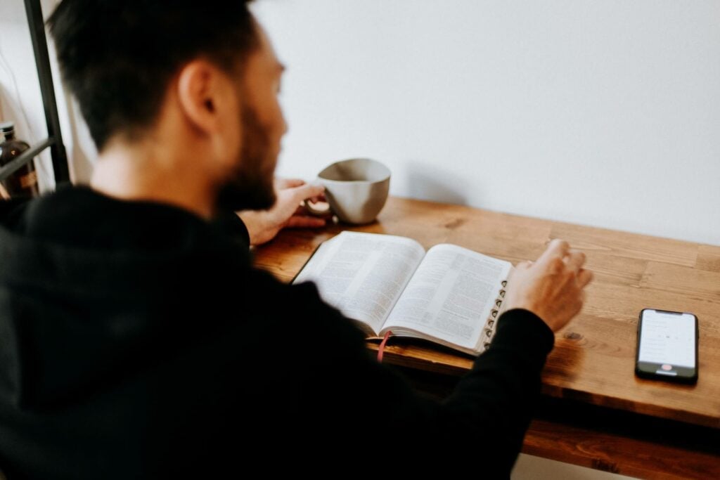 An image of a man reading his bible representing Dare 2 Share's blog titled 5 Common Youth Pastor Struggles and How to Combat Them