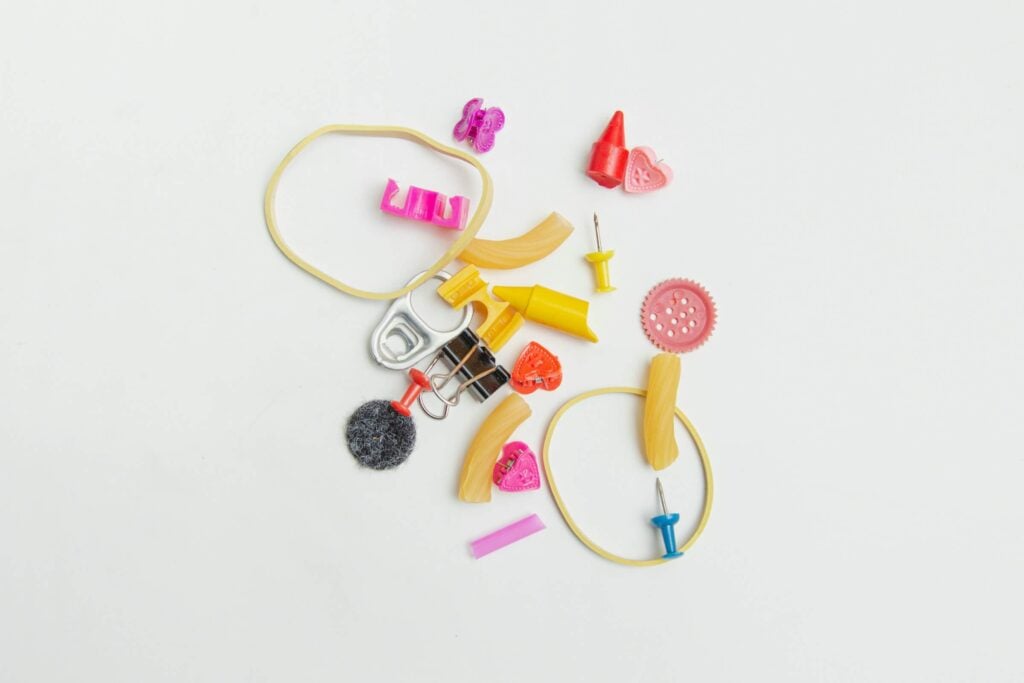 An image of random items such a rubber bands, buttons, and thumb tacks, representing Dare 2 Share's blog titled Youth Group Games With a Purpose.