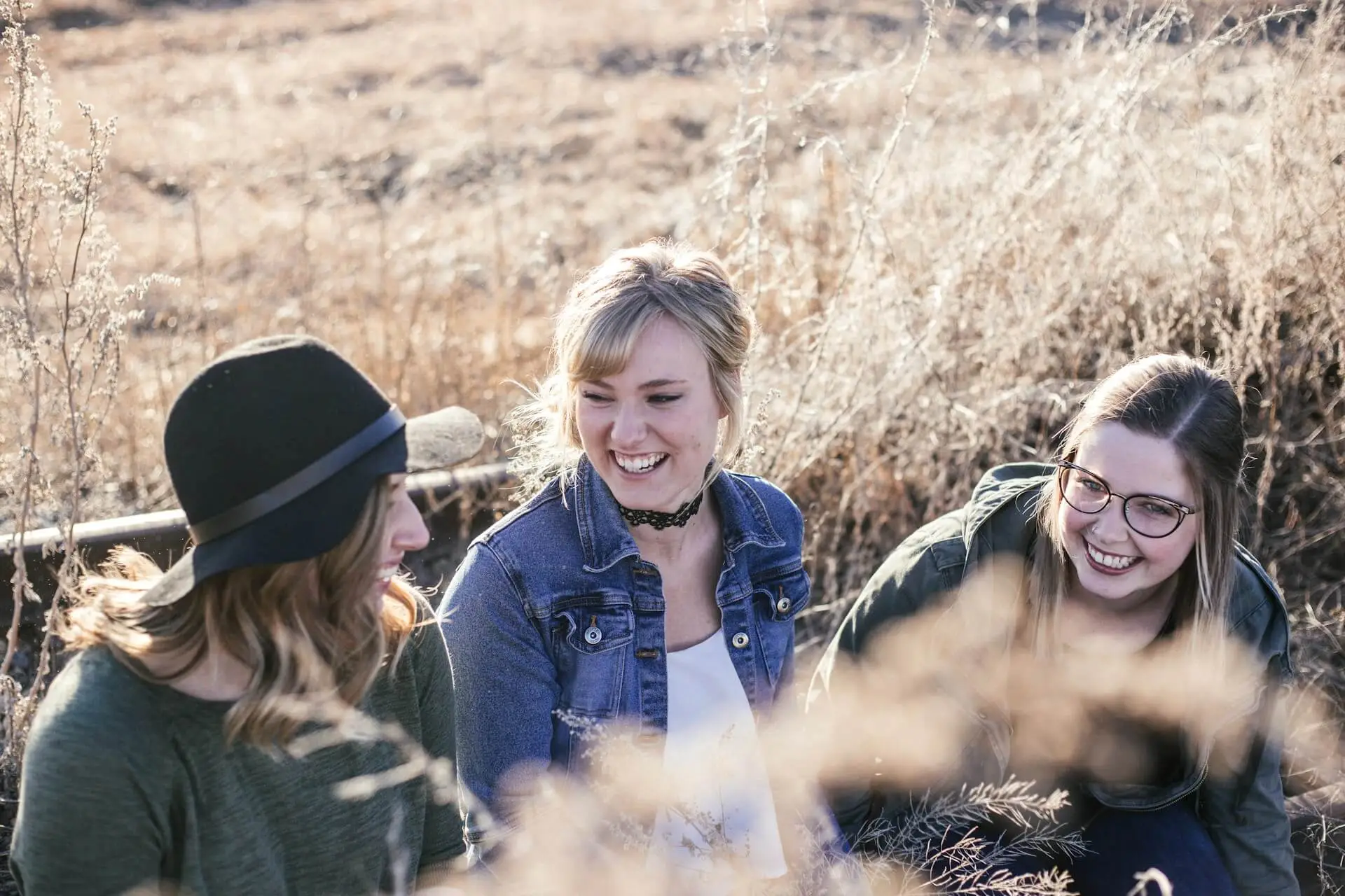 An image of three teenage girls outside representing Dare 2 Share's blog titled 4 Outdoor Youth Group Games! [With Spiritual Applications]