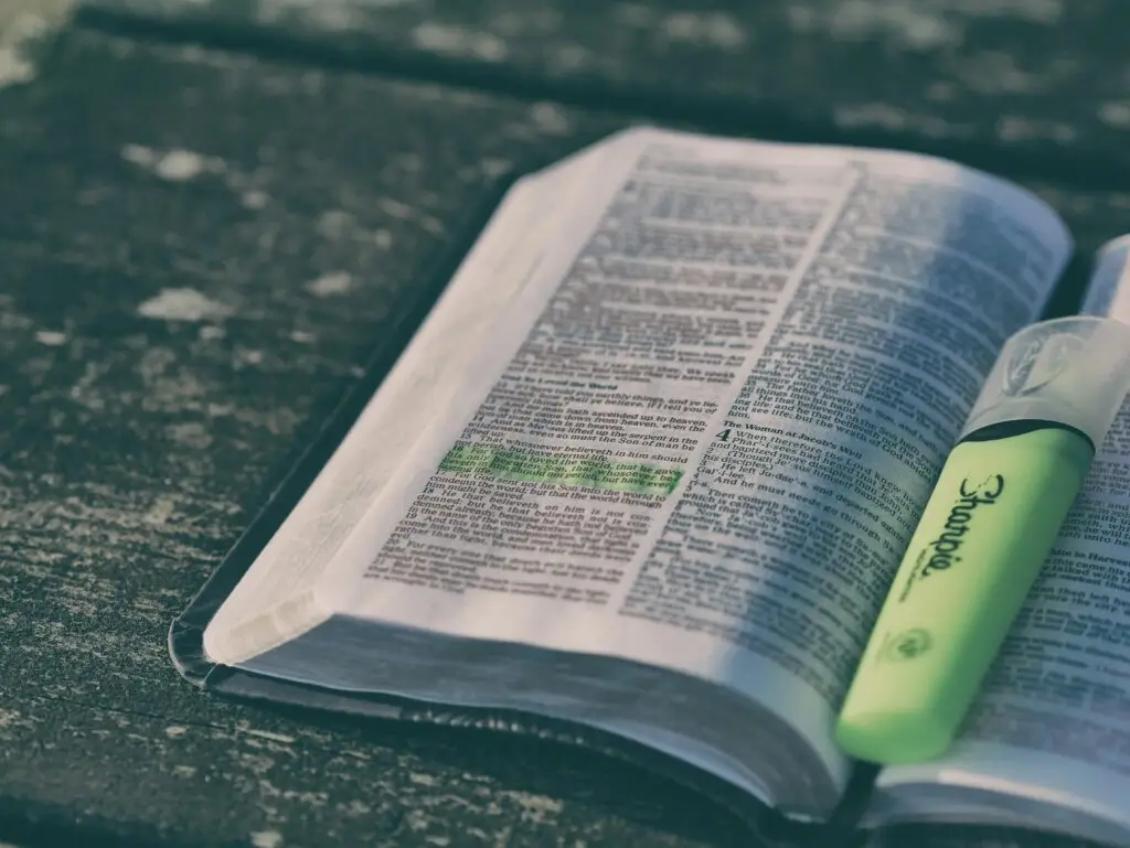 Image of an open Bible with a green highlighter on it representing Dare 2 Share's guide on how to be a youth pastor.