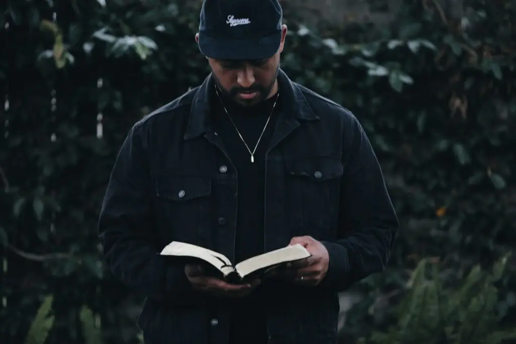 Young man looking at a bible representing Dare 2 Share's blog titled 4 Steps to Make Every Youth Meeting Gospel-Focused and Evangelistic.