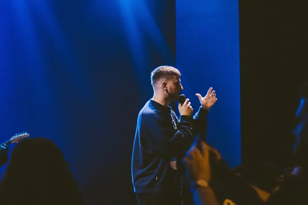 Image of a man preaching representing Dare 2 Share's blog titled How to Cast a Bold Vision for Your Youth Ministry: 5 Steps to Unlocking Its Potential