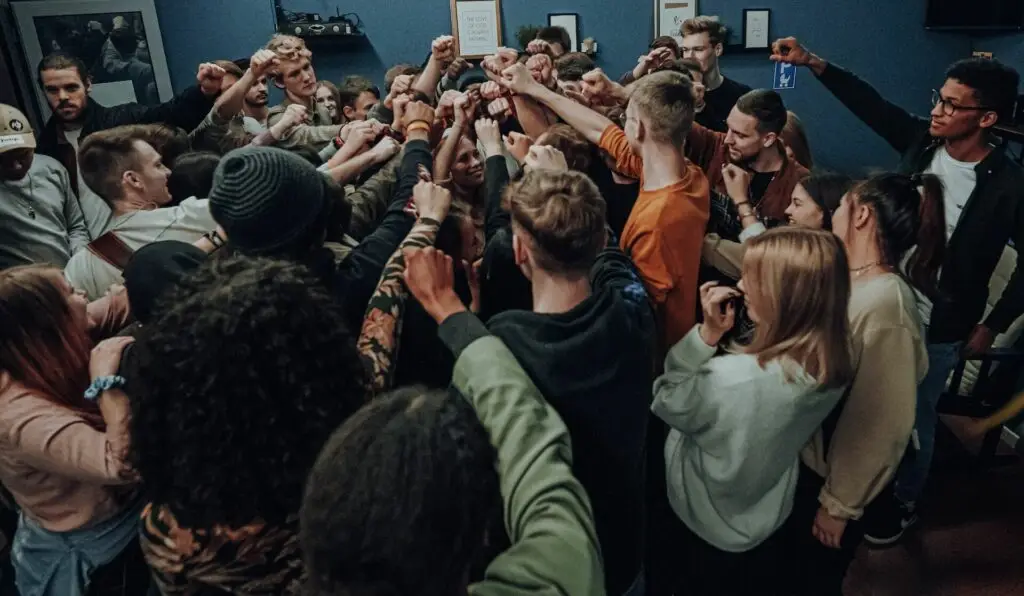 Image a group of students putting their hands together representing Dare 2 Share's blog How to Cast a Bold Vision for Your Youth Ministry: 5 Steps to Unlocking Its Potential