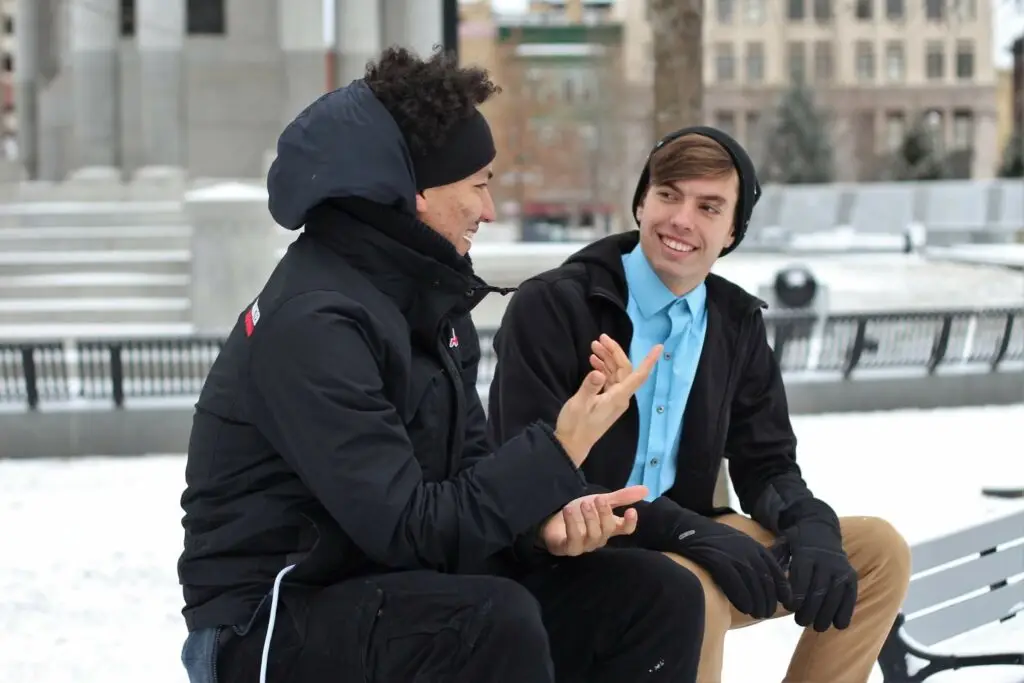 An image of two teenage guys talking representing Dare 2 Share's blog titled How to Implement the 7 Values of a Gospel Advancing Ministry