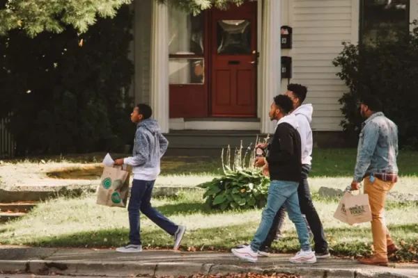 4 teenage boys walking down a sidewalk at Dare 2 Share LIVE