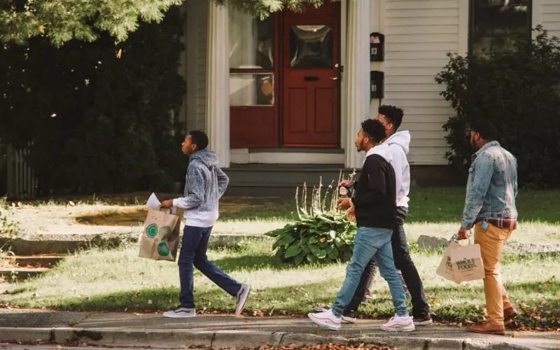 4 teenage boys walking down a sidewalk at Dare 2 Share LIVE