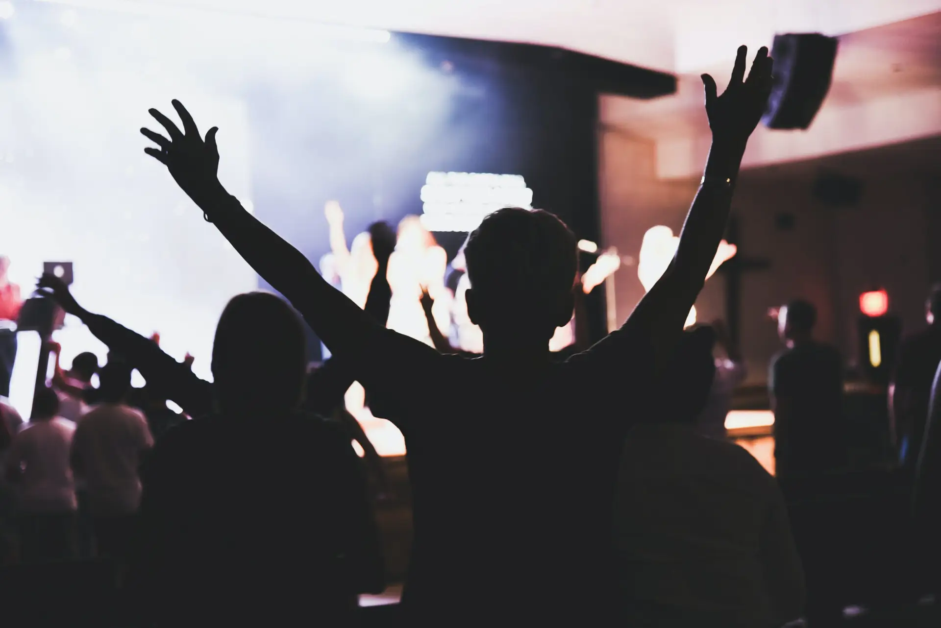 Revival as shown by kids raising their hands in worship