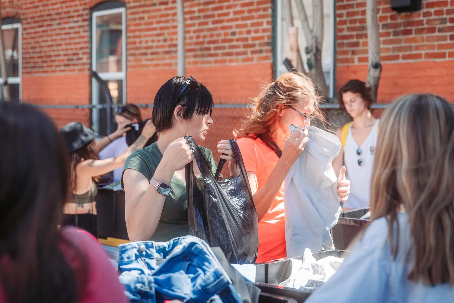 Students sharing the Gospel while giving out clothing!