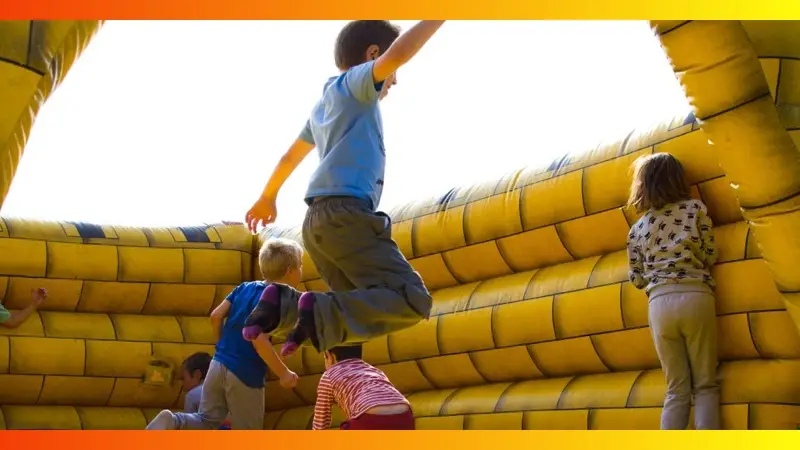 Kids jumping inside a bounce castle