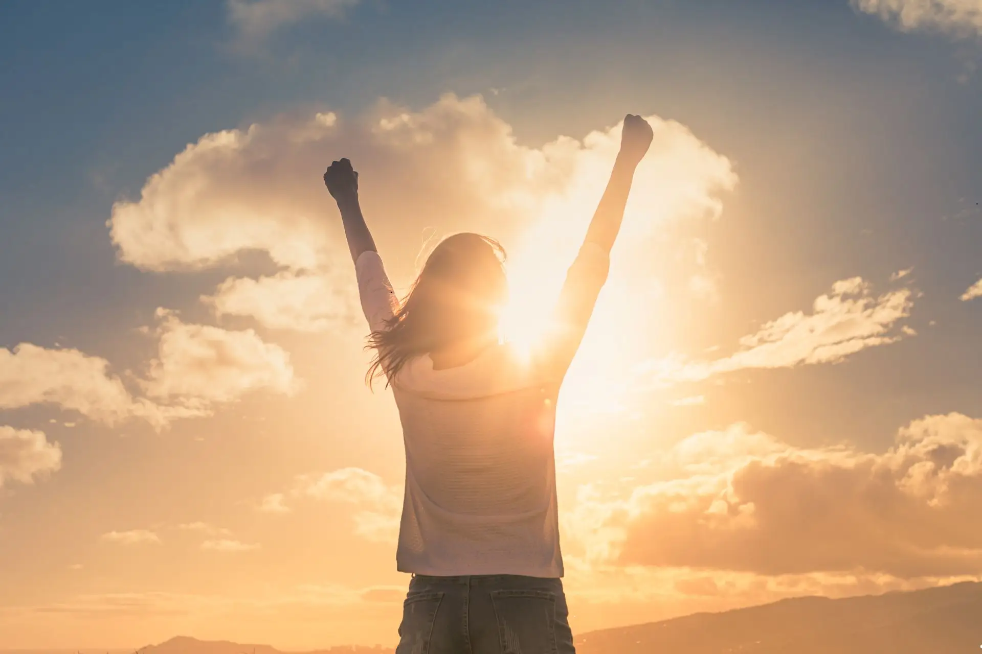 Image of a female youth leader with her hands raised in celebration because she overcame her youth ministry's youth discipleship challenges by being a Gospel Advancing Ministry.
