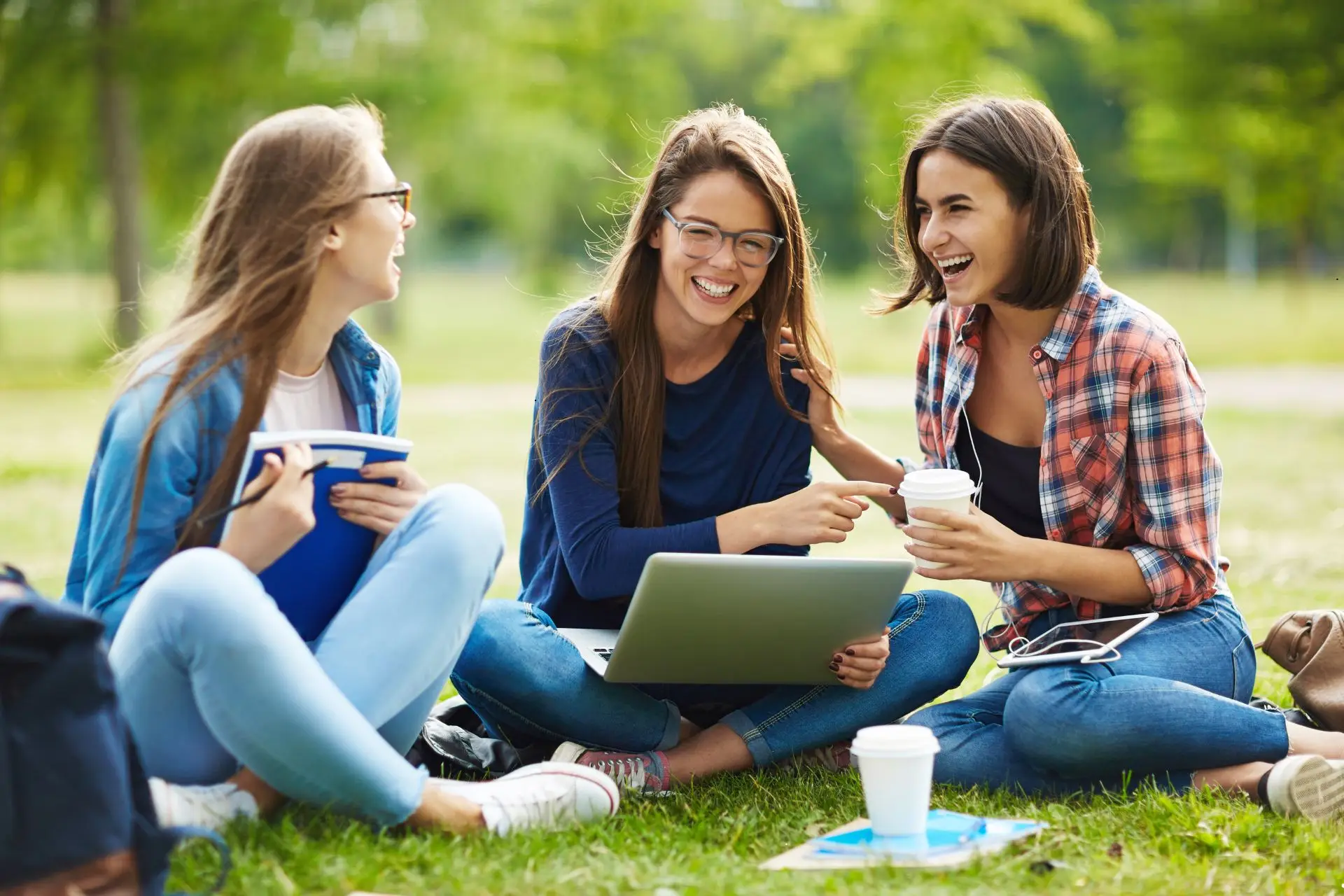 An image of three high school teenage girls sitting outside in a discipleship program representing discipleship testimonies that come from Gospel Advancing Ministry leader.