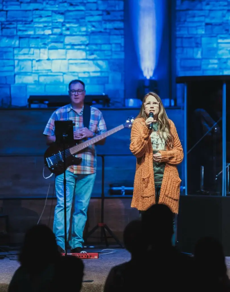 An image of a teenage girl singing in church representing Dare 2 Share's blog about why spiritual development is more important than numbers.